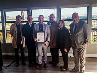 Councilmembers with Fire Chief Samson at the Yautch Club holding their certificate from the City