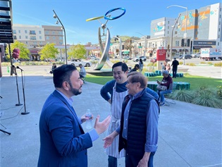 Mayor Eddie speaking with the owner of Wildflour at the Karyl Matsumoto Plaza