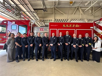 Group photo of firefighters in front of fire engine