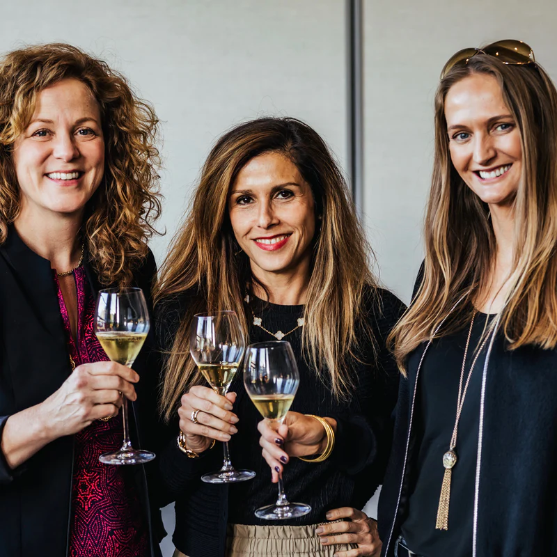 three women holding glasses of wine