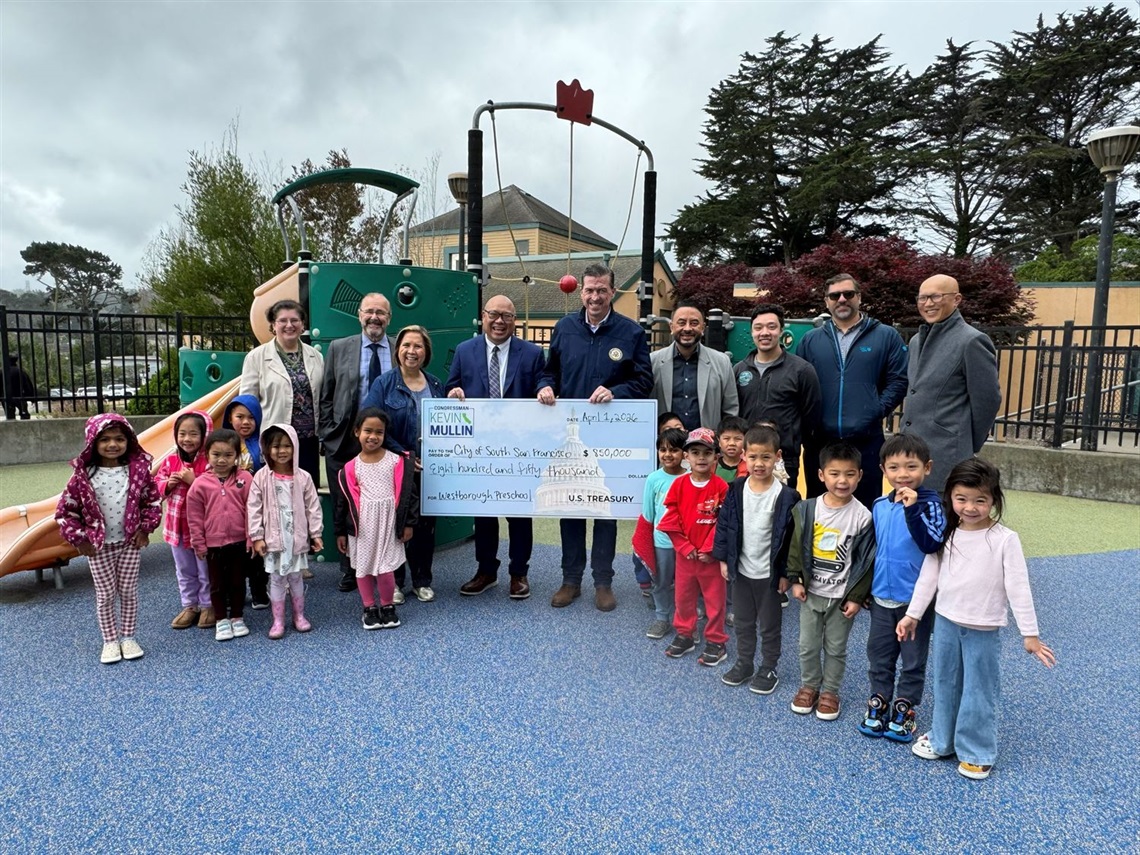 City Council with Congressman Kevin Mullin, City Manager, Assistant City Manager, and Parks & Recreation Director standing with children and showing off the $850,000 check at the Westborough Preschool