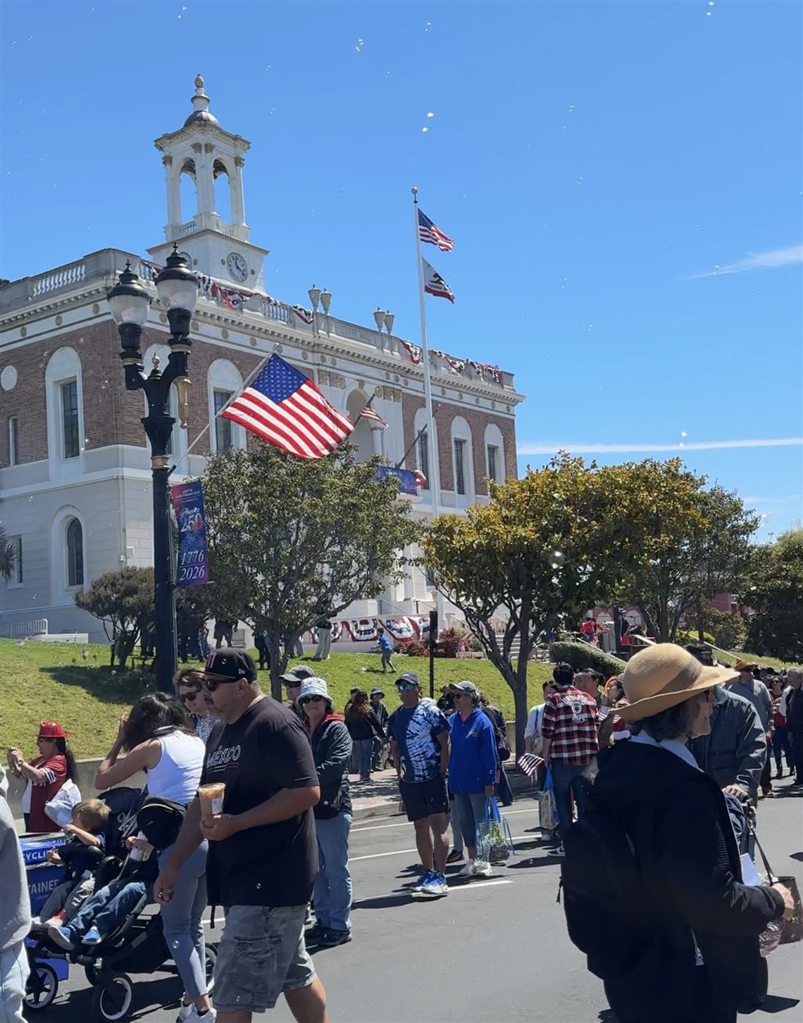 Several community members on Grand Avenue outside of City Hall at the 4th of July Parade and Picnic