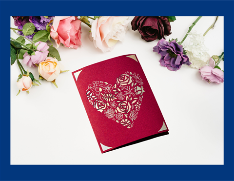 Red foiled insert Valentine's Day greeting card with flowers arranged above.