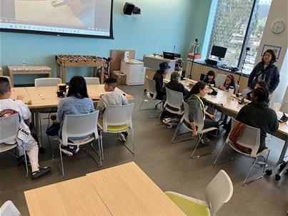 Patrons making diddley bow instruments