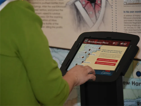 Image of a person reading a placard about American revolutionary places
