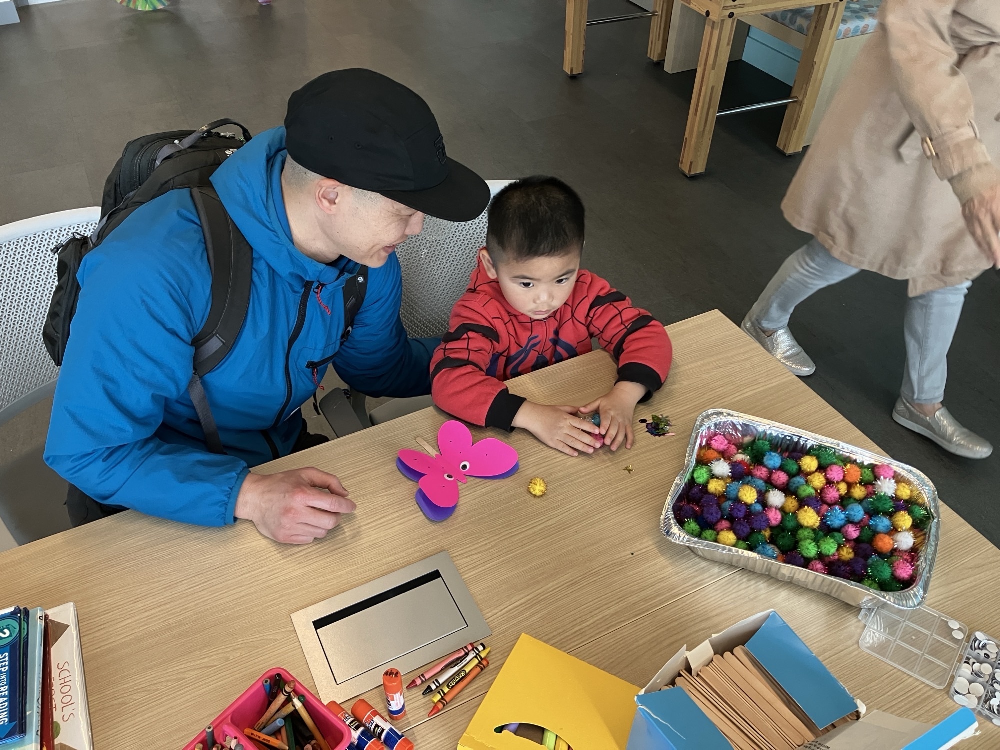 Adult and child making butterfly craft