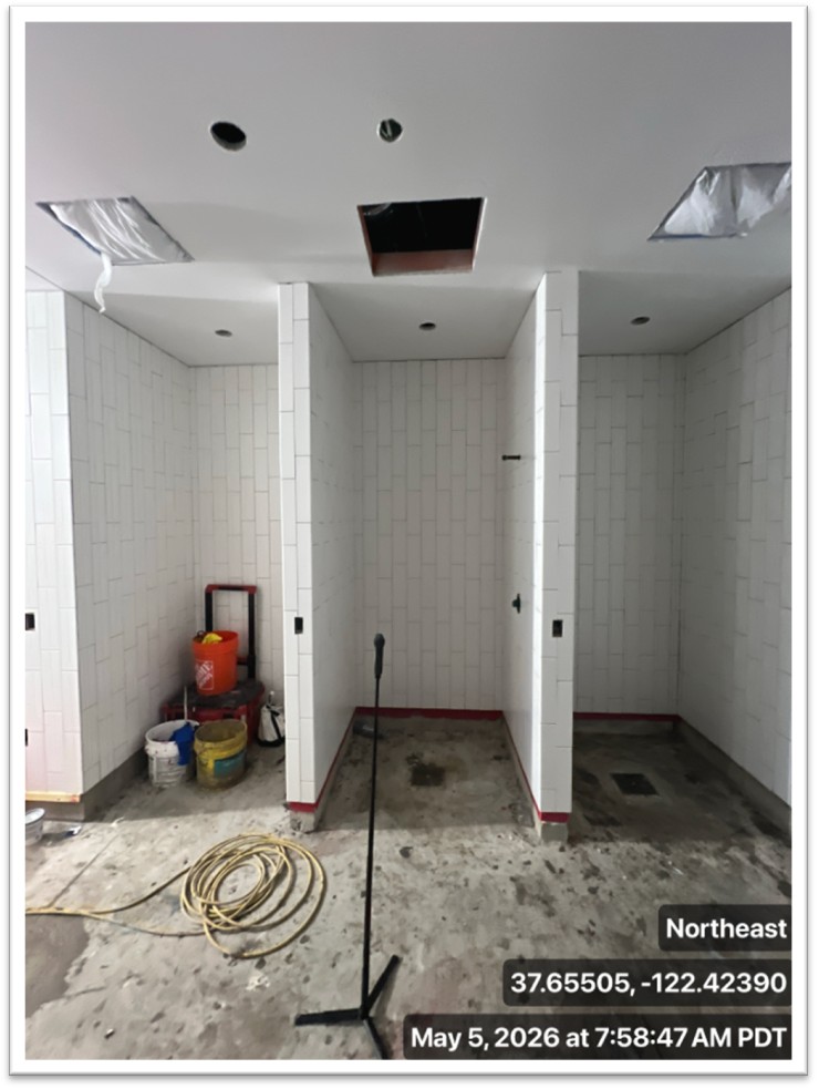 three stalls with white tiles