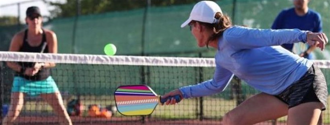 women playing pickleball