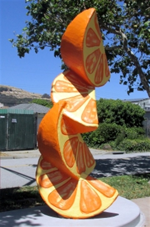 sculpture of 4 orange slices stacked on top of each other