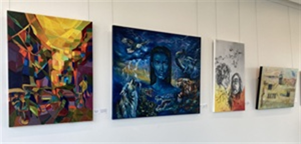 four paintings on a wall