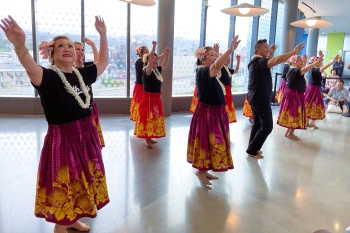 Over 7 individuals dancing the Hula