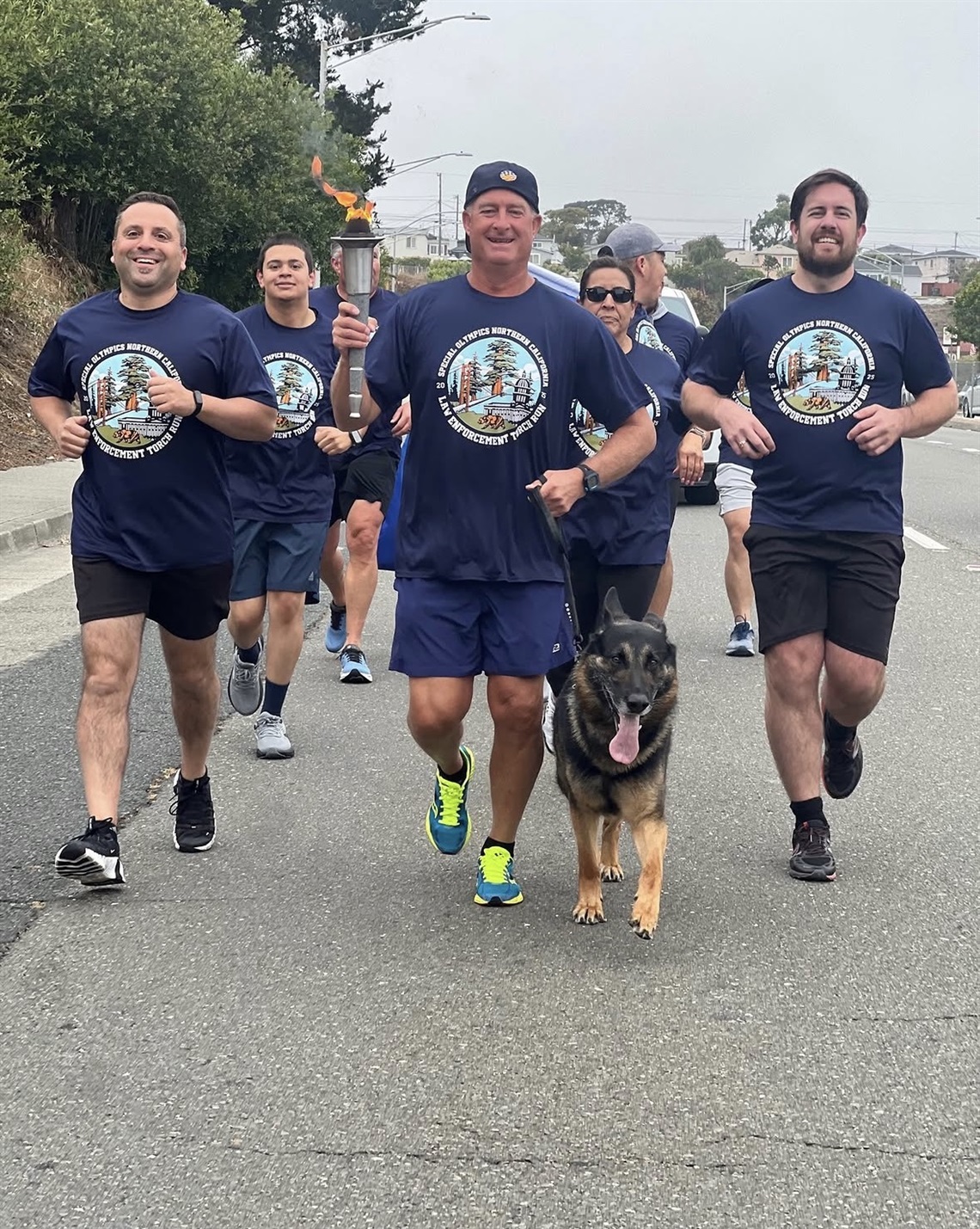 Members of the SSF Police Department running on El Camino Real wearing navy blue shirts