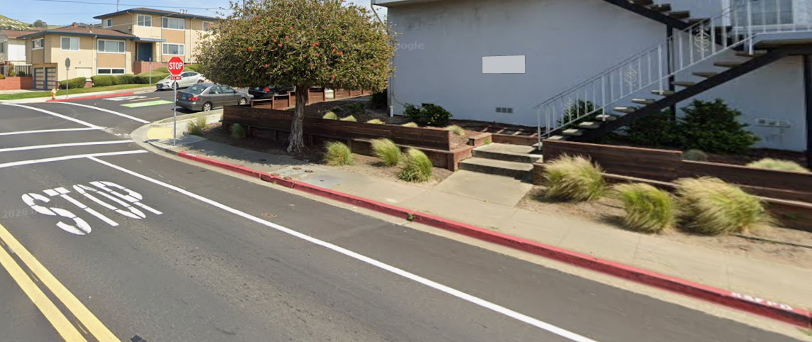 Painted red curb at the intersection of Commercial Avenue and Orange Avenue