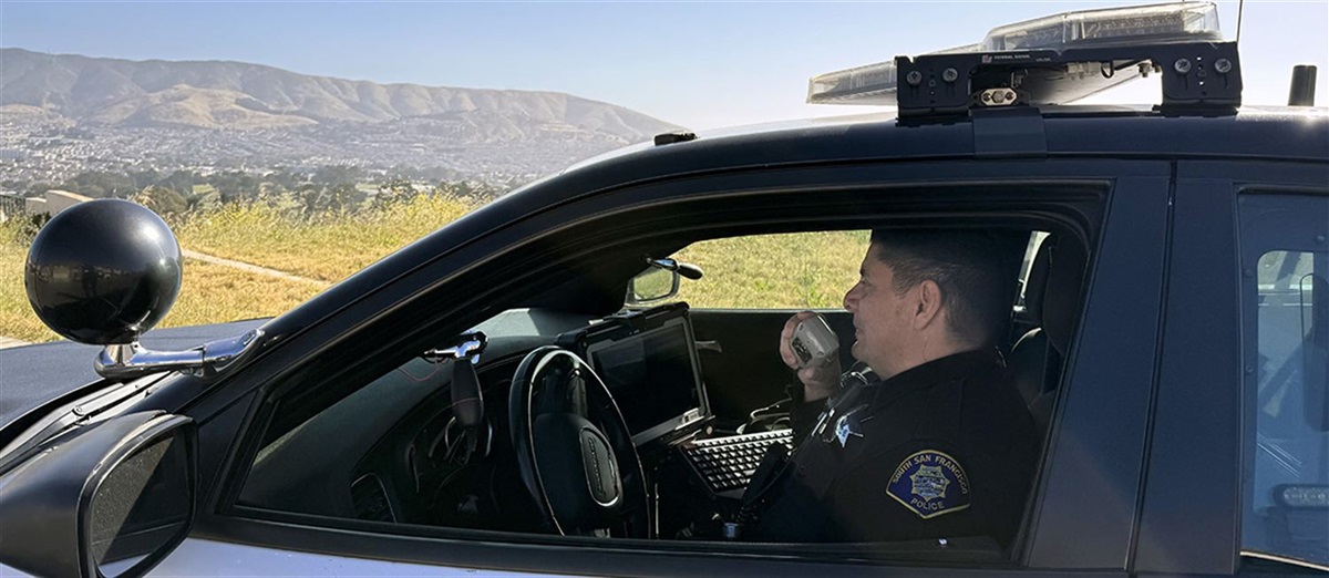 Operations - Officer in Police Car.jpg