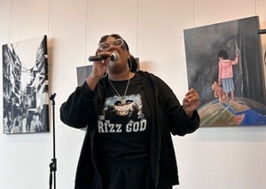 Woman singing in front of paintings