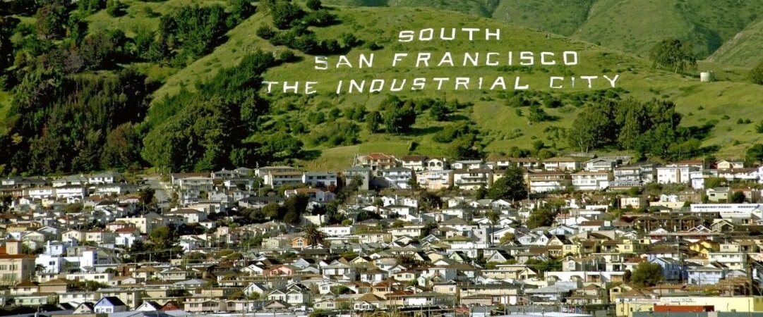 Historic hillside sign reading 'South San Francisco: The Industrial City.'